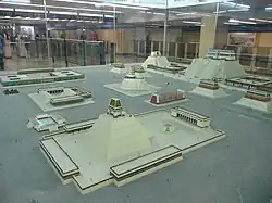 A scale model of several Aztec pyramids and buildings.