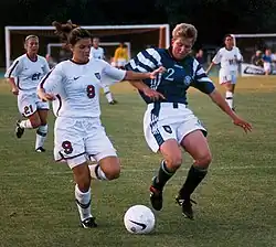 Image 18Mia Hamm (left) battles with German defender Kerstin Stegemann (from Women's association football)