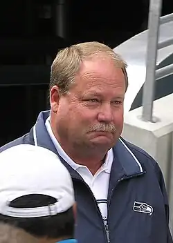 Photo of Holmgren from the shoulders up wearing a Seahawks jacket