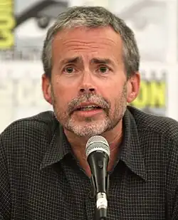 Mike Scully speaking into a microphone