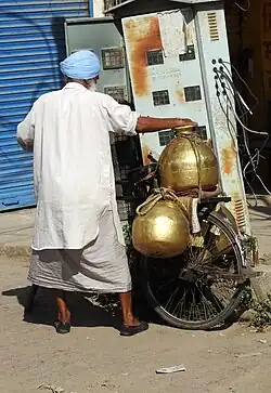 Milk vendor with typical traditional brass containers, called Gagar, used in the Majha region of Punjab