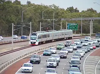 A freeway with a railway in the median strip
