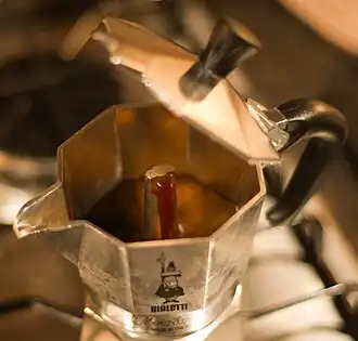 Mid-brew, showing brewed coffee in the process of being transported through the spout
