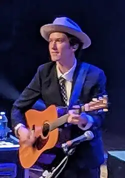 Mason Via playing a guitar