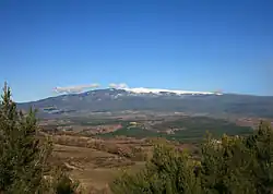Forested mountain, with white peak