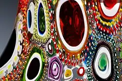 Close up of pattern of different murrine incorporated into blown glass.