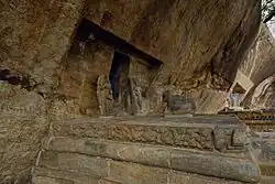 Rock-cut Siva Temple called Paliyili Iswaran with structural moulded plinth in front.