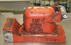 Image of an orange cockpit voice recorder that was recovered from the wreckage located at the Australian Transport Safety Bureau's technical facility in Canberra