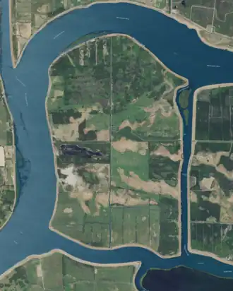 Aerial photo of a happy yet embattled little island.