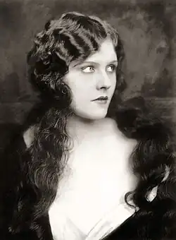 Sepia-toned portrait of a woman with long dark hair looking to the right