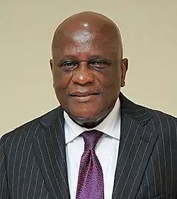 black bald male wearing a suit