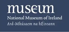 The word "museum" in stylised lower-case text, with the name of the museum in Irish and English below.
