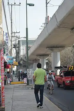 Photograph of a concrete bridge spanning an avenue.