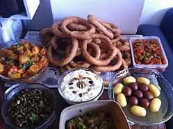 Sel roti with various Nepalese curries and sweets