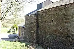 Newland Furnace. The blowing chamber with charging floor above is to the left of the stack. The cement scar is from a roof over the waterwheel.