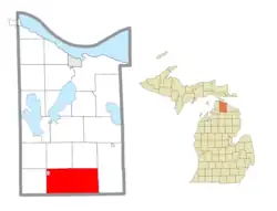 Location within Cheboygan County (red) and an administered portion of the village of Wolverine (pink)