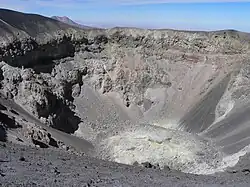 A crater-like depression with grey and white rocks