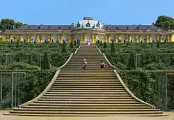 Single story pale yellow ornate palace stretching from the left foreground to the right background