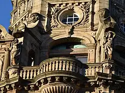 Pair of semi-nude female figures in niches flanking balustrade and window, floor 5, bay 5, Princes Street façade & Tower façade at corner of South St David Street