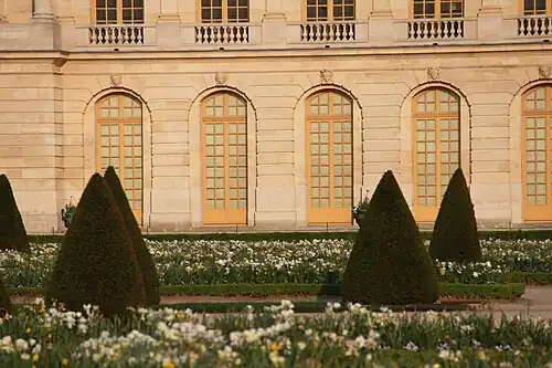 Baroque mascarons of various ages above doors of the garden facade of the Palace of Versailles, sculpted by Gaspard and Balthazard Marsy, Pierre Ier Le Gros, Benoît Massou and others, mostly from 1673-1674[32]