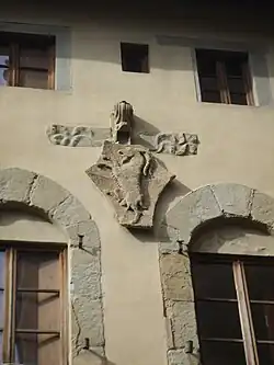 Façade: the arms of the Arte dei Beccai
