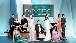 An image of the cast, a blue background. The series title is displayed on the upper center of the image.