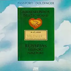 A green German passport with a logo of two hands shaking, a heart, and a label with text "DOLDINGER"