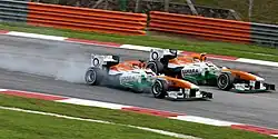 Paul di Resta overtaking Adrian Sutil in identical cars
