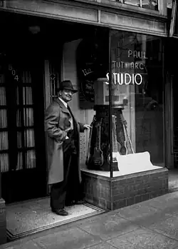 Paul Tutmarc outside his Seattle music studio
