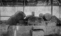 Stone tomb where the pillars on top have clearly subsided and leaned over time