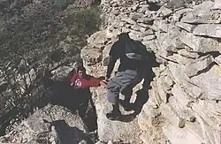 Hikers on the steep one hundred foot drop trail in Indian Mesa.