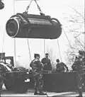 Soldiers removing a motor from its container in an operation like the 1985 incident