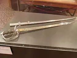 The sword and scabbard which Alexander Oswald Brodie, who served as the Governor of the Territory of Arizona from 1902 to 1905, used during his service with the Rough Riders during the Spanish–American War. The exhibit is located in the second floor of the Arizona State Capitol Museum.