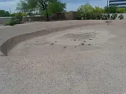 This was a Hohokam ballpark where they played ceremonial ball games. The villagers stood on top of the surrounding mound to observe the game.