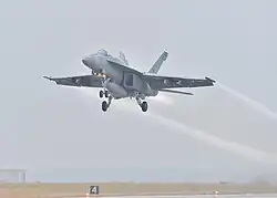 A Strike Fighter Wing Atlantic F/A-18 takes off from Naval Air Station Fort Worth Joint Reserve Base for the memorial flyover on December 6, 2018