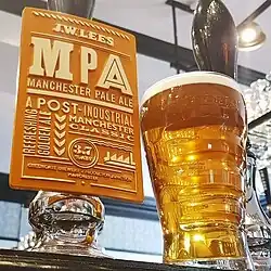 Pint of Manchester Pale Ale next to a pump clip