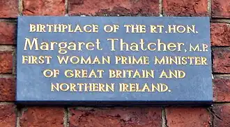 A plaque reading "Birth place of the Rt.Hon. Margaret Thatcher, M.P. First woman prime minister of Great Britain and Northern Ireland".
