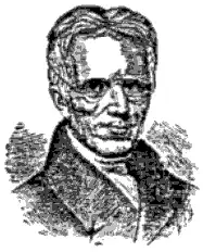 Black and white portrait of Daniel Dana, with glasses and combed-back hair, wearing a high-collared coat.
