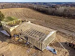 Post frame garage connected to traditional frame house
