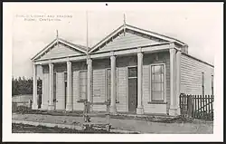 A black and white postcard of a single storey library building