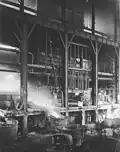 Pouring molten copper matte from a water jacket furnace, June 1912.