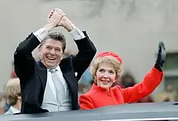 U.S. President Ronald Reagan and wife Nancy Reagan waving from the limousine during the inaugural parade in Washington, D.C. (1981)