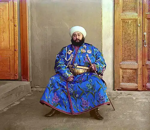 Alim Khan's bemedaled robe conveys a social message about his wealth, status, and power.