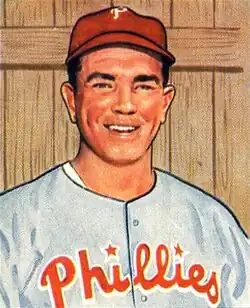 A baseball card image of a smiling man wearing a gray baseball jersey with "Phillies" in red across the chest and a red baseball cap with a white "P" on the front