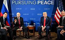 Putin and Trump flanked by some of their respective delegations