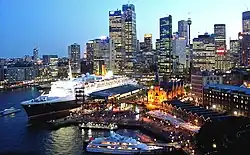The Queen Elizabeth 2 docked at Sydney Harbour, looking towards Circular Quay and the Sydney CBD