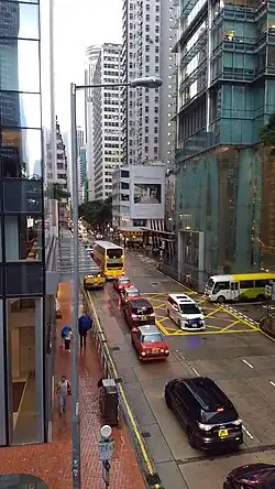 Western end of Queen's Road East on a rainy day, viewed from the overpass. Three Pacific Place is on the right. Hopewell Centre is visible in the distance.