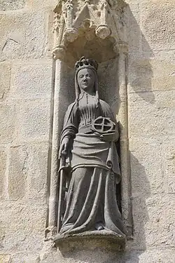 The south porch has this statue of Saint Catherine of Alexandria in a niche in the south buttress. She holds a wheel and a sword. It was on a wheel that she was martyred.
