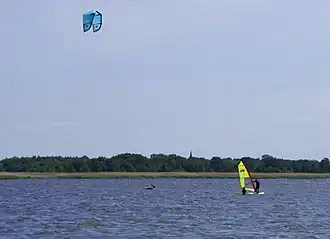A person is parasailing above the water.