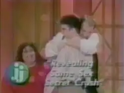 A title card for the episode "Revealing Same Sex Secret Crush" of the American television series The Jenny Jones Show; guests Jonathan Schmits (front) and Scott Amedure (back) are depicted embracing with the episode's title and the series' logo pictured in the center and left-side of the shot, respectively.